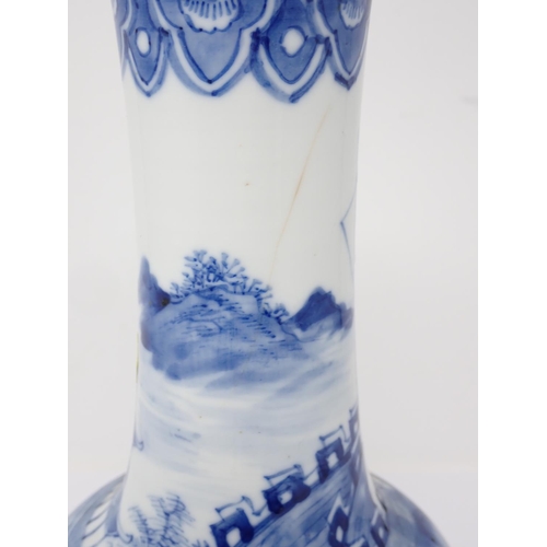 264 - A Chinese blue and white narrow necked Vase decorated with buildings in landscape 10in