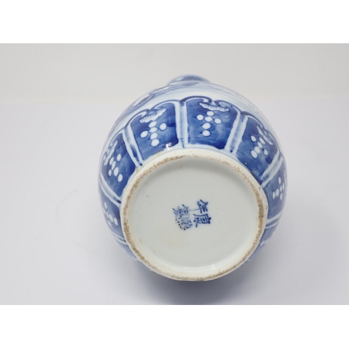 264 - A Chinese blue and white narrow necked Vase decorated with buildings in landscape 10in