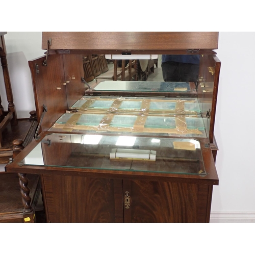 293 - An oak Tea Trolley on barley twist supports and a mahogany veneered Cocktail Cabinet