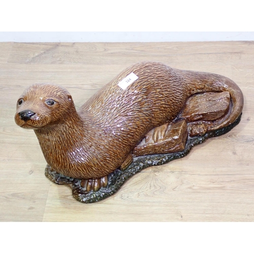 324 - A glazed stoneware figure of an Otter