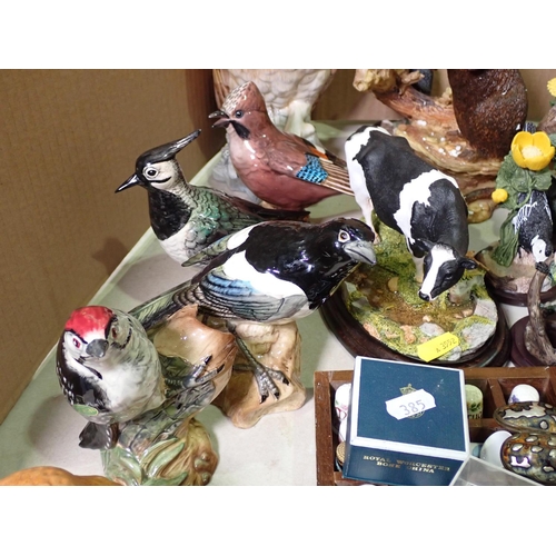 385 - A quantity of Beswick and other birds, Wade Wimsies, Thimbles, Otter, Cow, two Jaguar Car Mascots