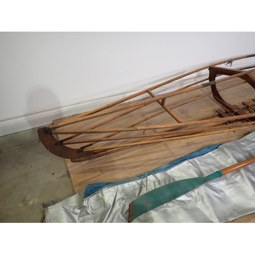 574 - A collapsible wooden Canoe Frame and Paddle