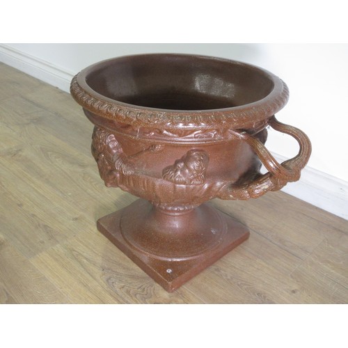 294A - A saltglaze two-handled Urn on detachable pedestal base with elaborate pierced handles with bearded ... 