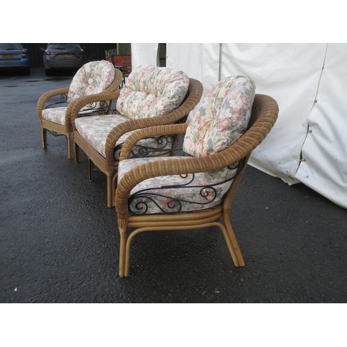 525A - A cane and wrought iron three piece Conservatory Suite with floral upholstered cushions