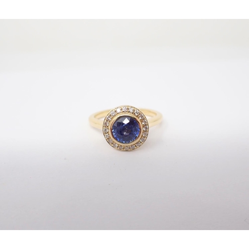 651 - A Sapphire and Diamond Cluster Ring rubover-set round sapphire, 1.00ct, within frame of pavé-set bri... 