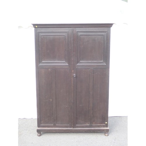 5 - A panelled oak two door wardrobe 6ft 2in H x 4ft 3in W