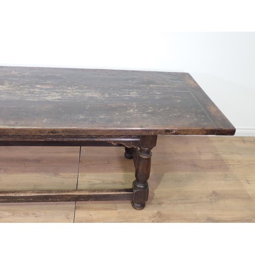 30 - A 17th Century style antique oak Refectory Table with plank top, on base with turned baluster suppor... 