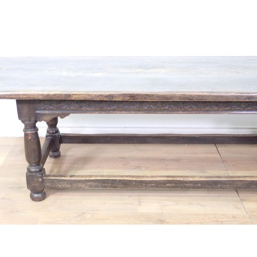 30 - A 17th Century style antique oak Refectory Table with plank top, on base with turned baluster suppor... 