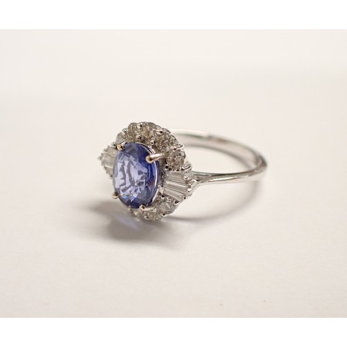 154 - A Sapphire and Diamond Cluster Ring claw-set oval-cut sapphire, 1.58cts, within a frame of baguette ... 