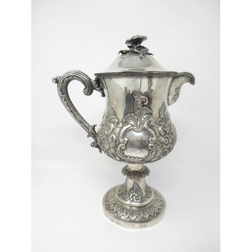 133 - A Continental silver Pedestal Jug with oval reserve of rowing and sailing boats, floral and leafage ... 