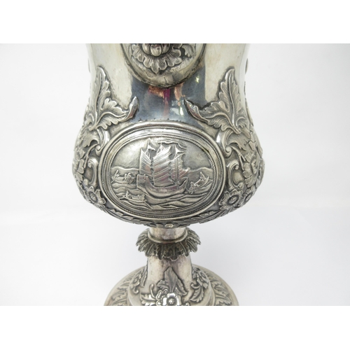 133 - A Continental silver Pedestal Jug with oval reserve of rowing and sailing boats, floral and leafage ... 