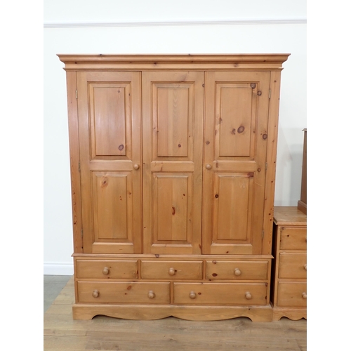 15 - A modern pine Bedroom suite comprising triple Wardrobe, double Wardrobe, Dressing Table and pair of ... 