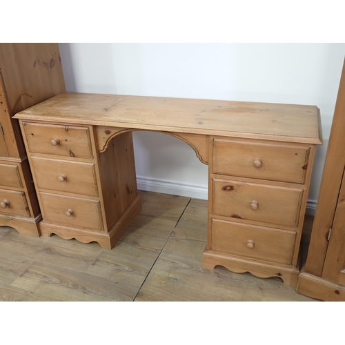 15 - A modern pine Bedroom suite comprising triple Wardrobe, double Wardrobe, Dressing Table and pair of ... 