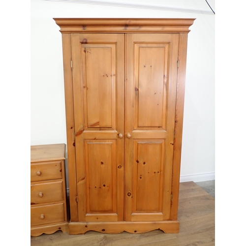 15 - A modern pine Bedroom suite comprising triple Wardrobe, double Wardrobe, Dressing Table and pair of ... 