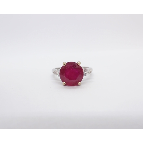 158 - A Ruby and Diamond three stone Ring claw-set round ruby, 4.86cts between two pear-cut diamonds in 18... 