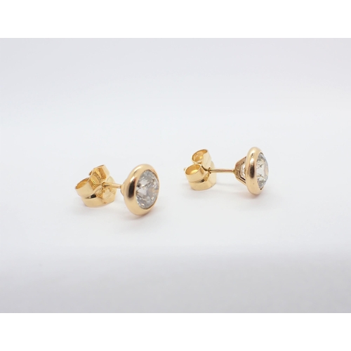 165 - A Pair of Diamond Ear Studs each rubover-set brilliant-cut stone in 18ct gold