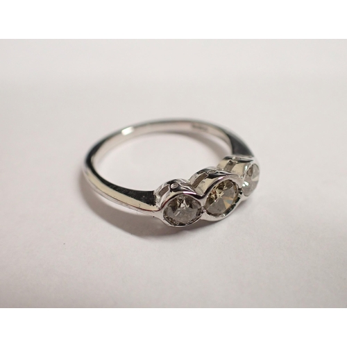 168 - A Diamond three stone Ring rubover-set champagne brilliant-cut stone between two lighter stones in 1... 