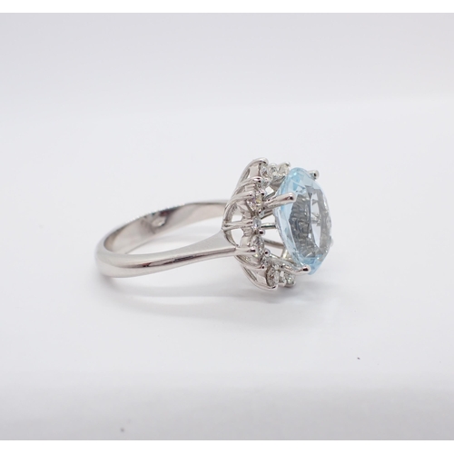 178 - An Aquamarine and Diamond Cluster Ring claw-set oval mixed-cut aquamarine, 4.70cts, within a frame o... 