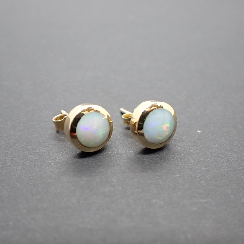 243 - A pair of Opal Ear Studs each with round opal in 9ct gold mount