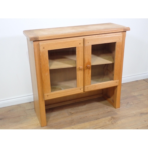 415 - A modern oak and glazed two door Bookcase