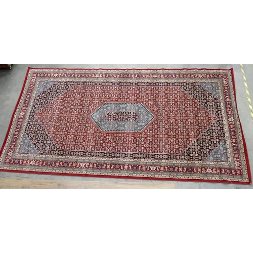 433 - A large modern red ground Carpet with overall floral design within border 14ft 8in L x 7ft 8in W