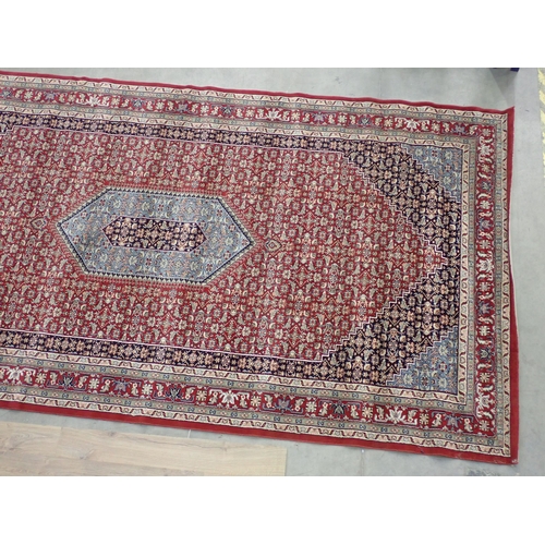 433 - A large modern red ground Carpet with overall floral design within border 14ft 8in L x 7ft 8in W