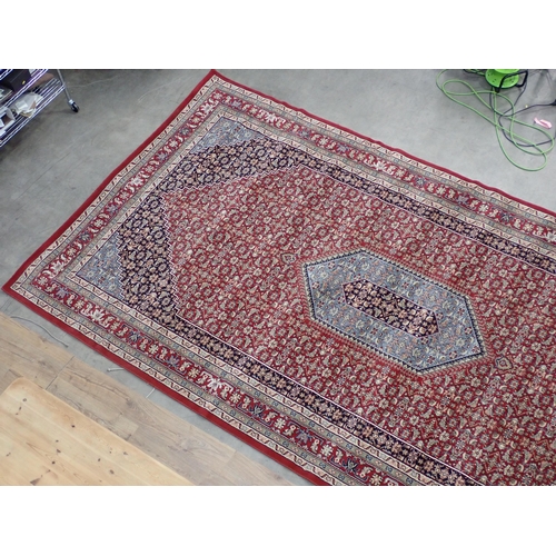 433 - A large modern red ground Carpet with overall floral design within border 14ft 8in L x 7ft 8in W