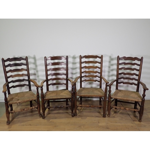 435 - Four antique ladderback Elbow Chairs with rush seats