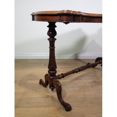 437 - A Victorian burr walnut veneered Centre Table with shaped top on cheval base on carved scrolled supp... 