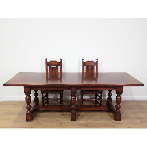 480 - A 17th Century style oak Refectory Table with cleated top mounted upon six turned supports with thic... 