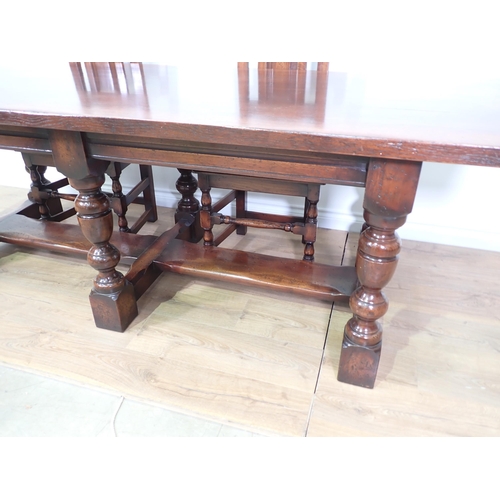 480 - A 17th Century style oak Refectory Table with cleated top mounted upon six turned supports with thic... 