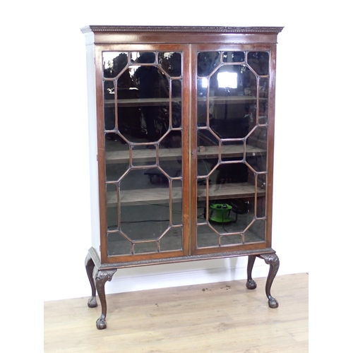 586 - A mahogany and astragal glazed Bookcase the two doors enclosing adjustable shelves mounted on cabrio... 