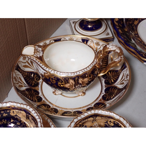 657 - A quantity of Crown Derby and other similar Teaware, with gilded decoration on a dark blue ground, s... 