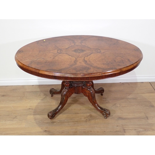 689 - A Victorian walnut veneered oval Loo Table on four scroll carved supports 4ft 4in W