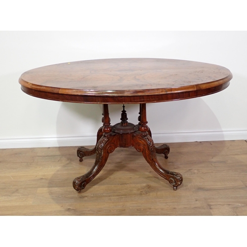 689 - A Victorian walnut veneered oval Loo Table on four scroll carved supports 4ft 4in W