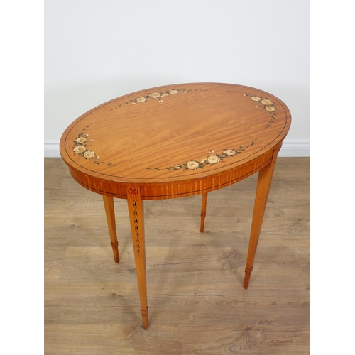 690 - An Edwardian oval satinwood Occasional Table with rose painted decoration mounted upon square cut ta... 