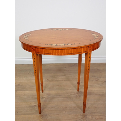 690 - An Edwardian oval satinwood Occasional Table with rose painted decoration mounted upon square cut ta... 