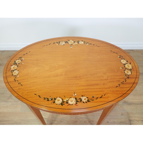 690 - An Edwardian oval satinwood Occasional Table with rose painted decoration mounted upon square cut ta... 