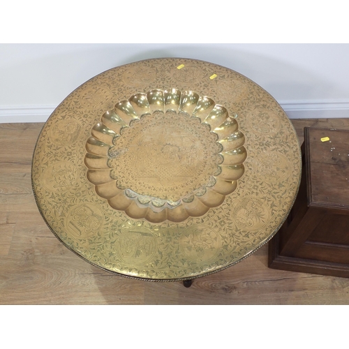 698 - An Eastern brass topped folding Table and a mahogany Plant Stand