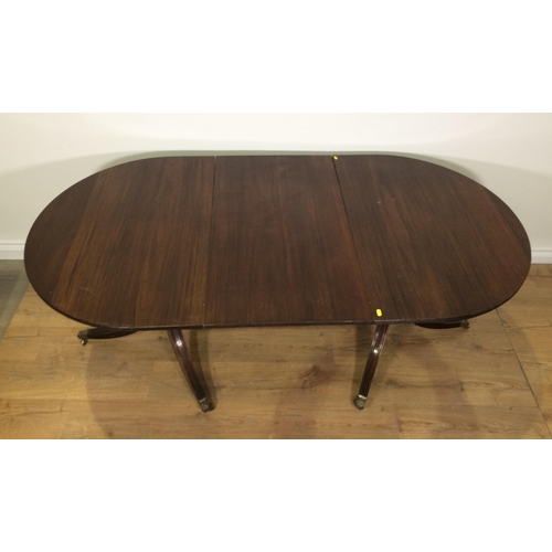 700 - A reproduction mahogany veneered twin pedestal Dining Table with spare leaf