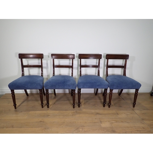 702 - A set of four 19th Century mahogany bar-back Dining Chairs with blue stuff-over seats