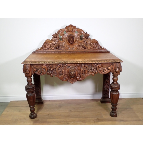 711 - A Victorian carved oak Serving Table with raised back and shaped apron with lion mask and acanthus l... 