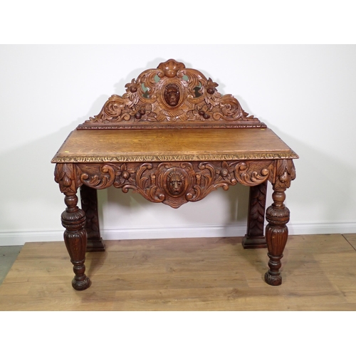 711 - A Victorian carved oak Serving Table with raised back and shaped apron with lion mask and acanthus l... 