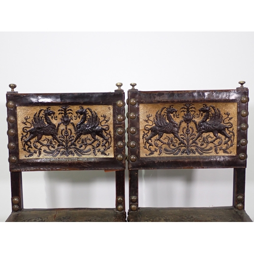 714 - A pair of oak Chairs with tooled leather back and carved front rail on square cut supports