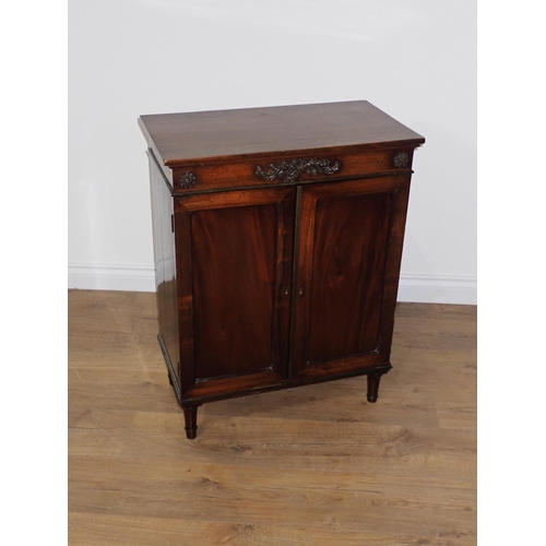 718 - A 19th Century mahogany and rosewood two door Cabinet on turned supports 2ft 7in H x 2ft W