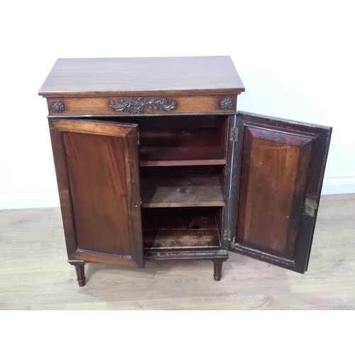 718 - A 19th Century mahogany and rosewood two door Cabinet on turned supports 2ft 7in H x 2ft W