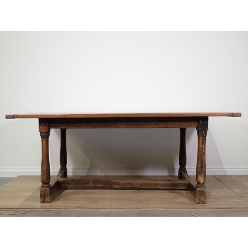 738 - An oak Refectory Table with cleated top on baluster turned supports united by H-stretcher 6ft 6in L ... 