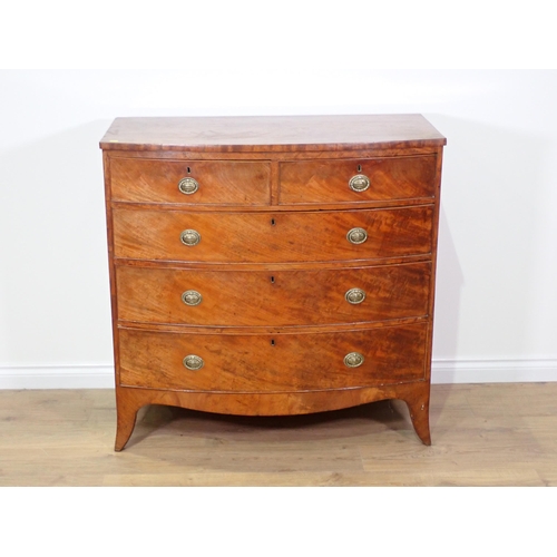 742 - A 19th Century mahogany bow front Chest of two short and three long drawers mounted upon splayed fee... 