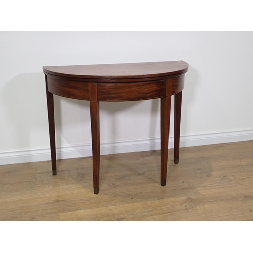 753 - A 19th Century mahogany demi-lune fold over Tea Table on square cut tapering supports 2ft 11in W x 2... 