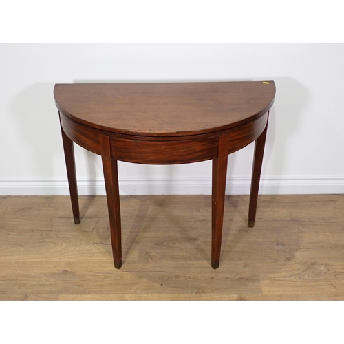 753 - A 19th Century mahogany demi-lune fold over Tea Table on square cut tapering supports 2ft 11in W x 2... 